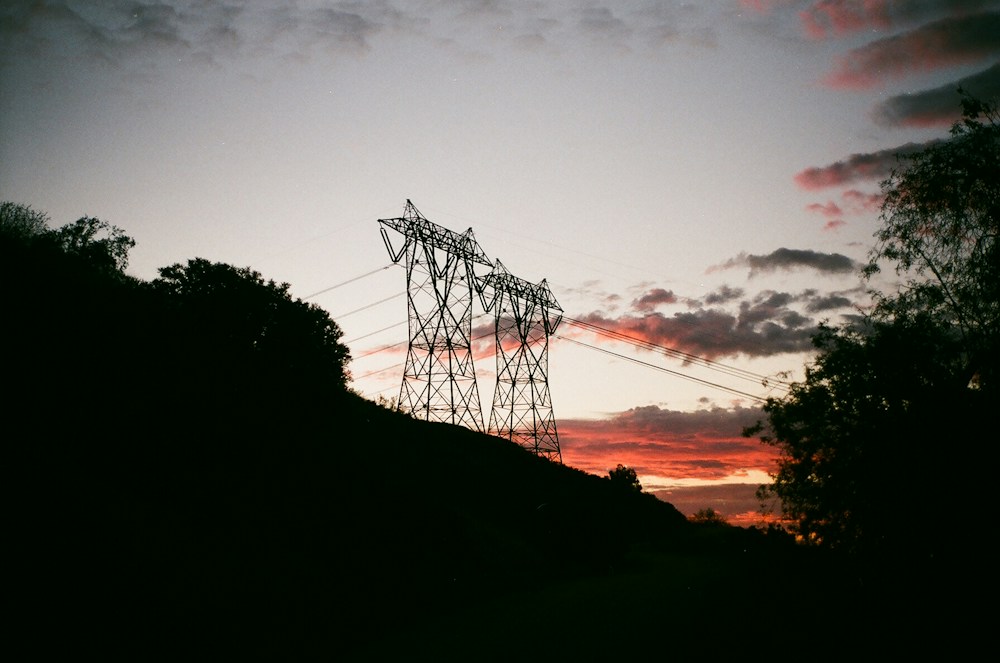 Electricity transmission towers at sunset